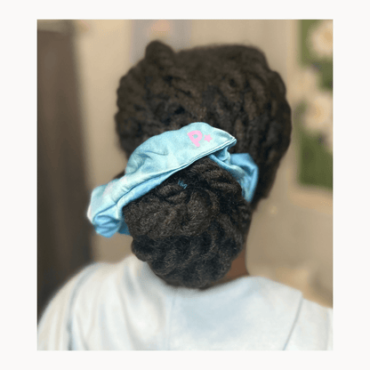 100% handmade stretch silk scrunchie in multi blue dye design displayed on model